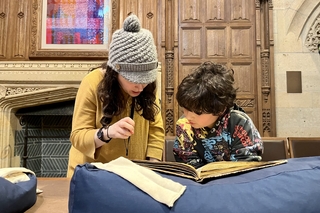 Visitors looking at a Passover book